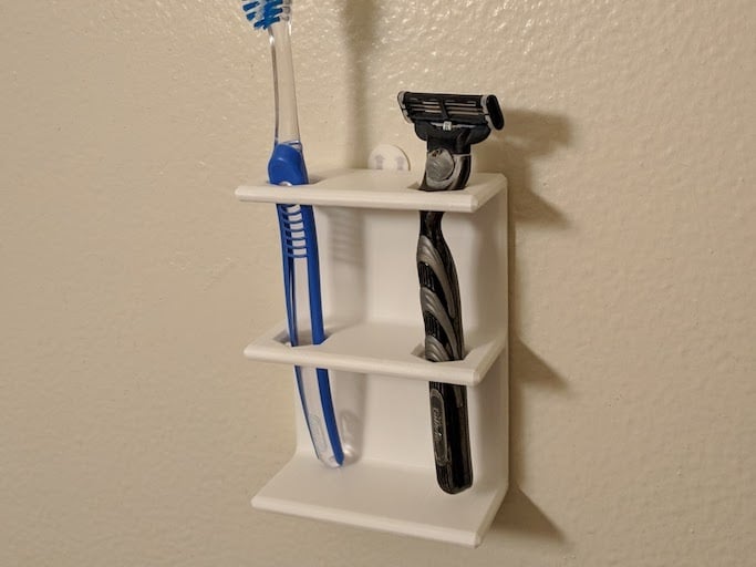 Supporto a parete per spazzolino o rasoio