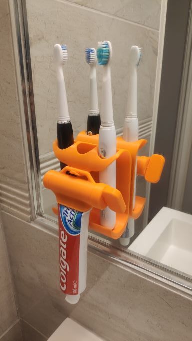 Supporto da muro e spremidentifricio per spazzolino
